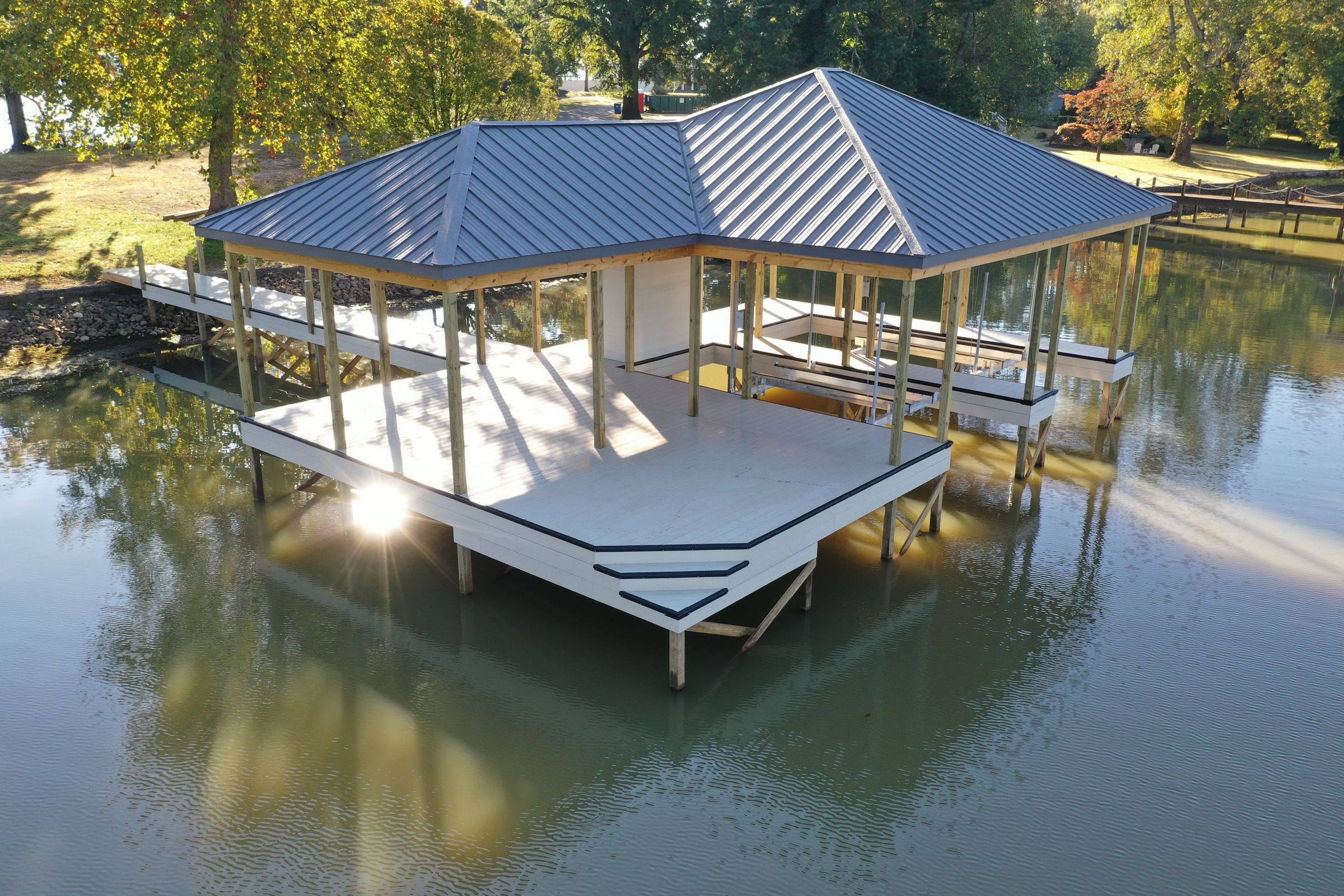 Aerial of a custom blue-roof double-slip boathouse built by Blue Horizon Docks and Decks on a Tennessee lake
