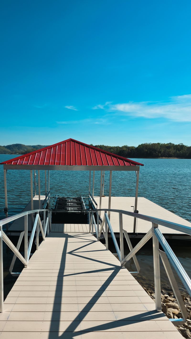 Aluminum gangway leading down to a red-roof floating dock