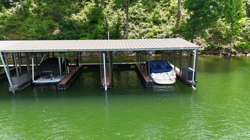 Covered multi-slip dock with boats on lifts