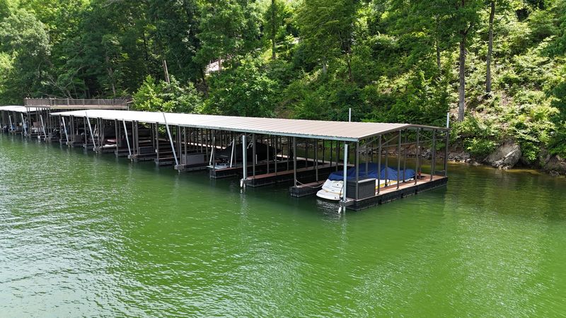 Long covered multi-slip dock along a wooded shoreline