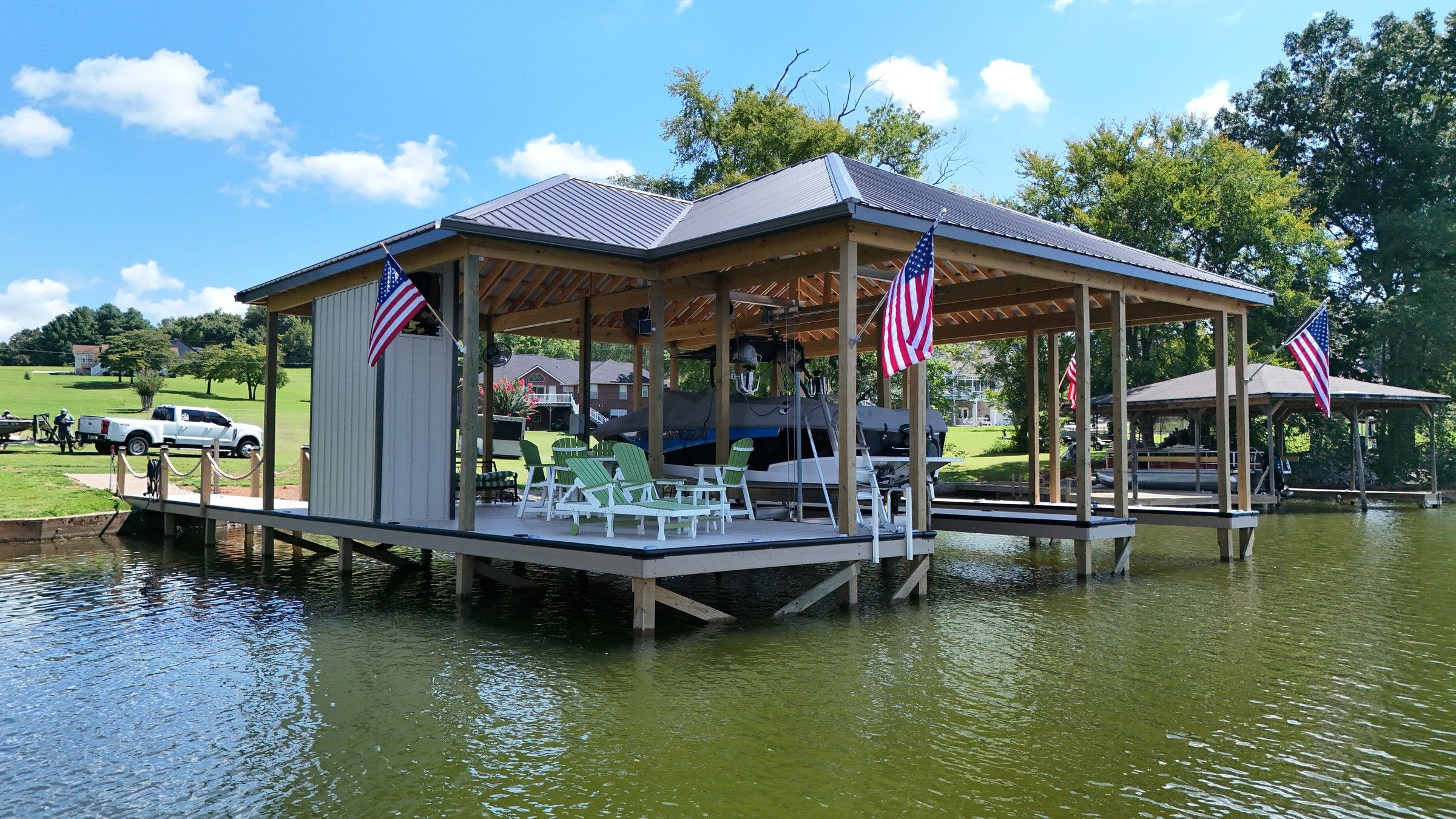 Covered dock with a seating area, storage room and double slip