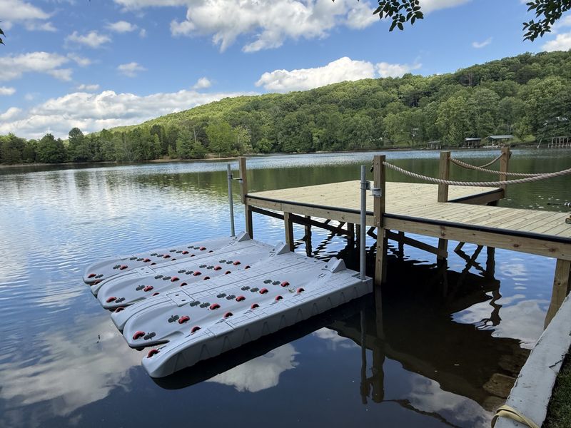 Shoreline dock with rope railing and floating PWC ports