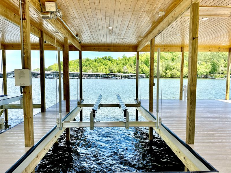 Aluminum cable boat lift installed inside a Blue Horizon covered boathouse, ready to raise the hull clear of the water