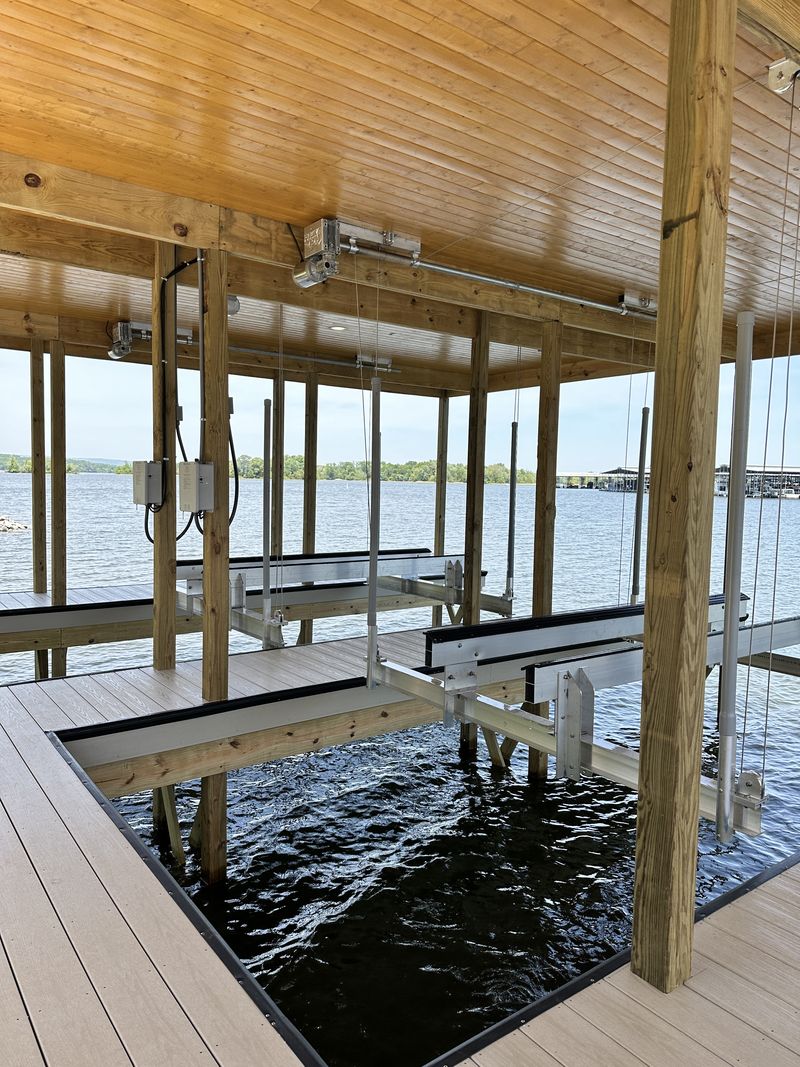 Boat lift installed by Blue Horizon with remote control, limit switches, and drive-on guides included